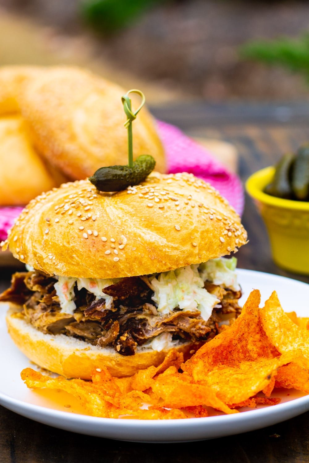 3- Ingredient Pulled Pork on a bun with potato chips.