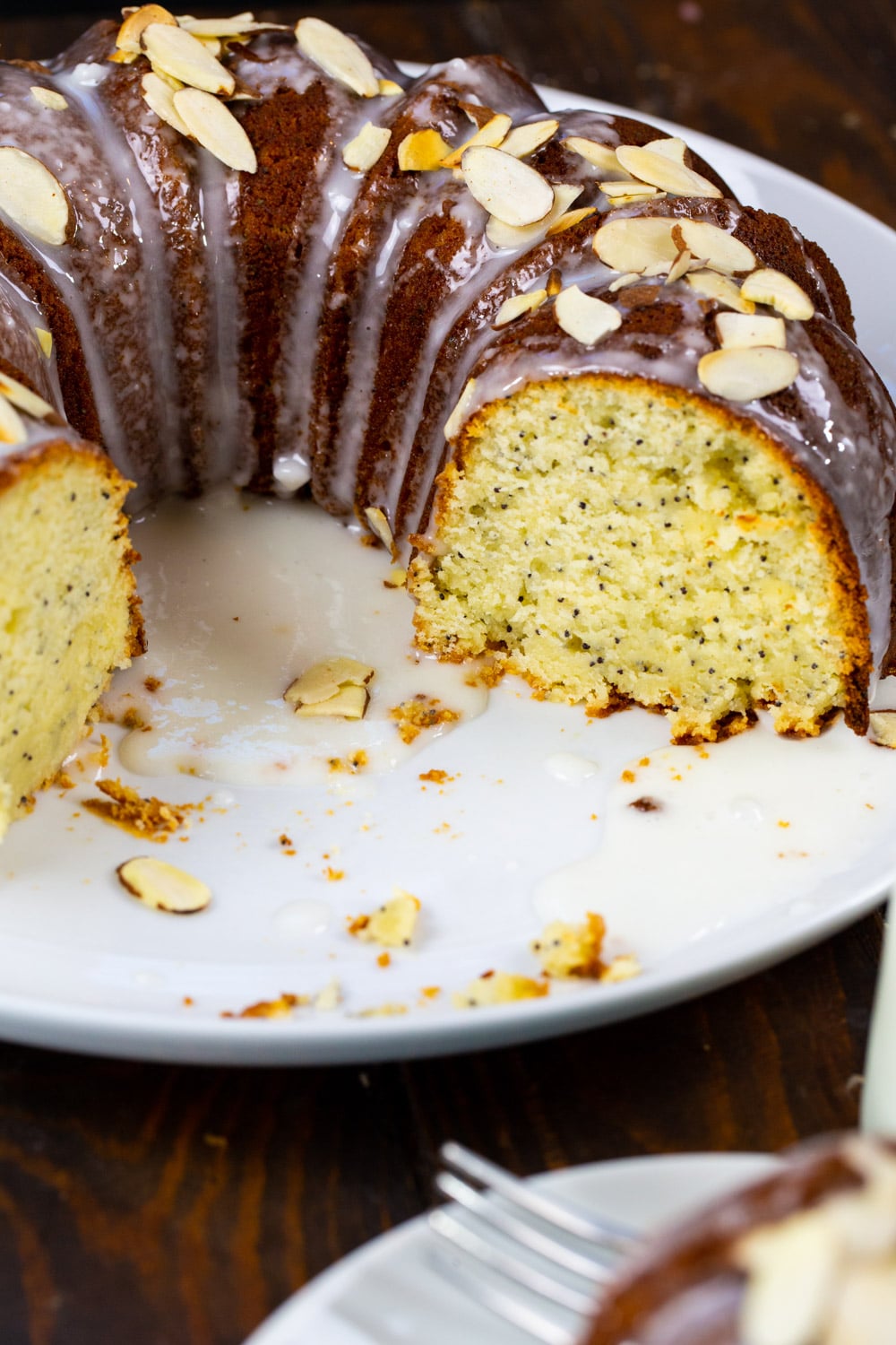 Pound Cake with a few slices cut out on a large plate.