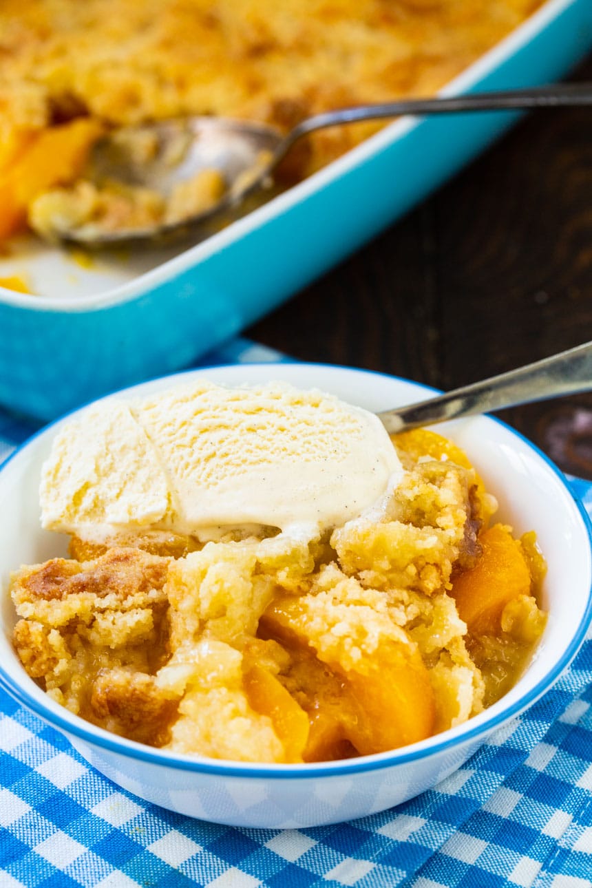 Peach Cobbler in a bowl with vanilla ice cream