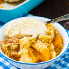 Peach Cobbler in a bowl with vanilla ice cream