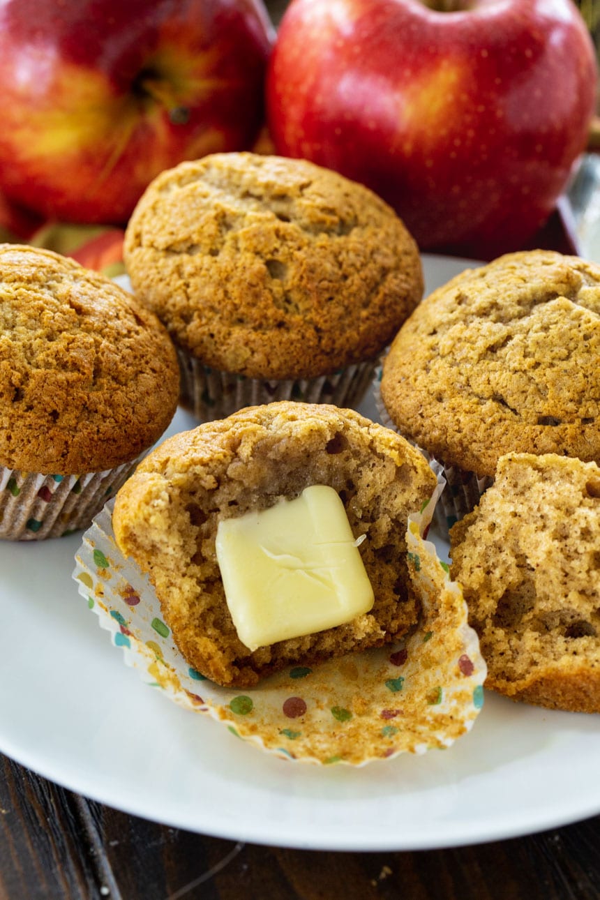 Apple Butter Muffin cut open with a piece of butter on it.