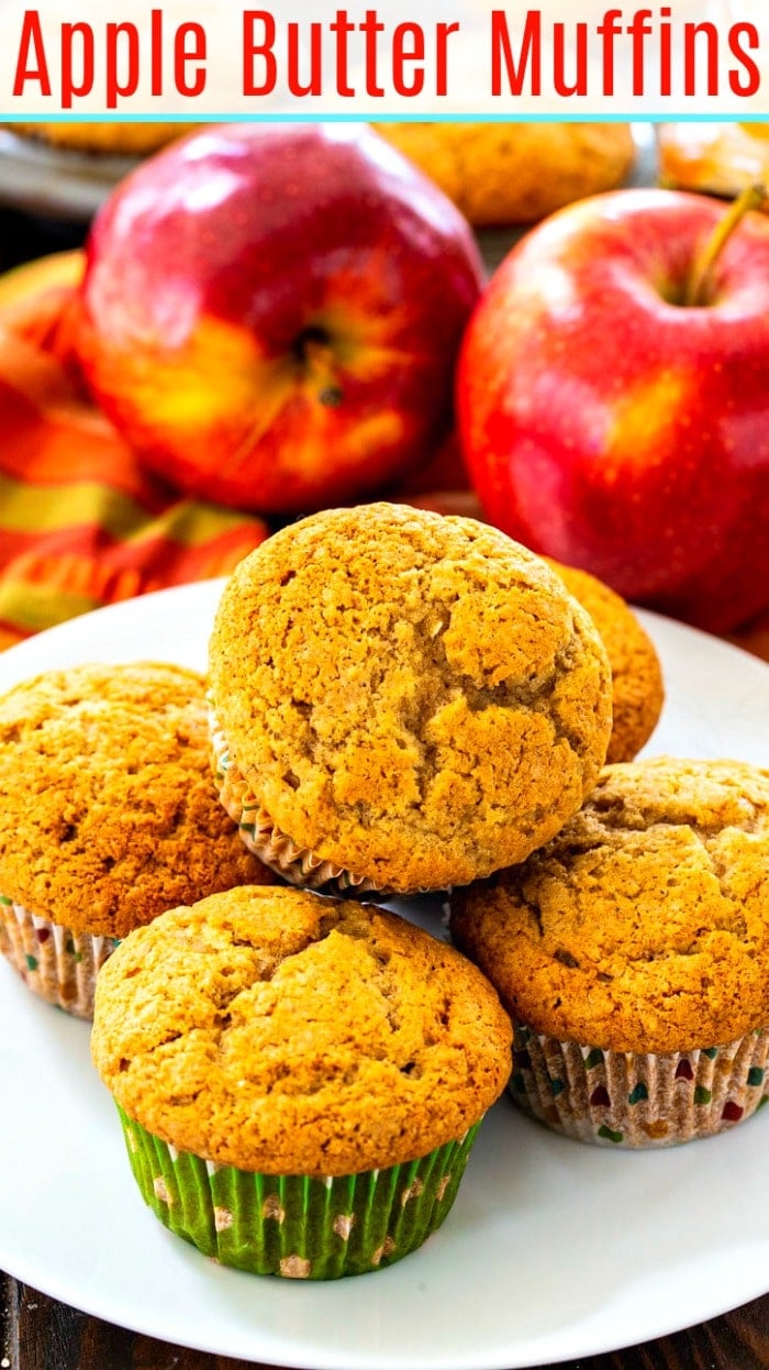 Apple Butter Muffins on a plate with apples in background.