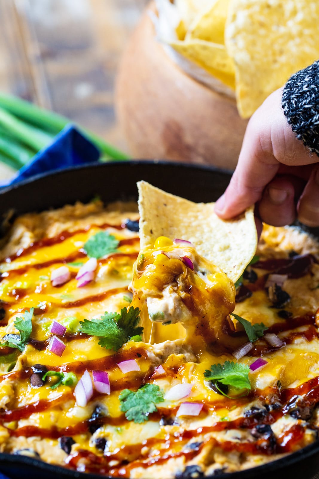 Chip scooping up BBQ Chicken Dip.