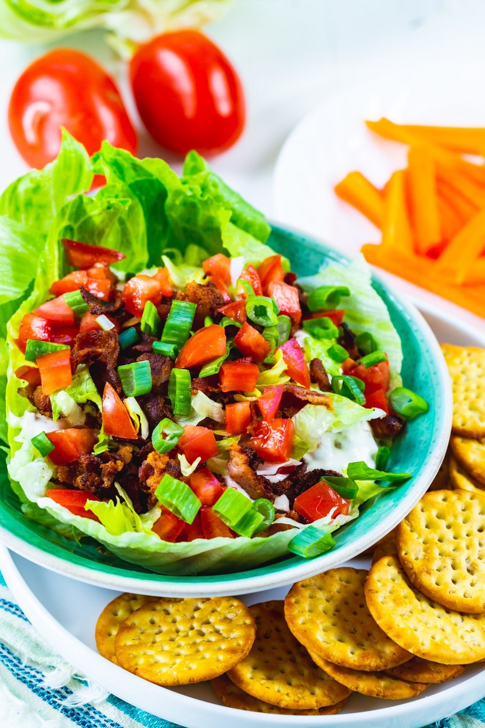 Creamy BLT Dip topped with shredded lettuce, chopped tomatoes and crumbled bacon.