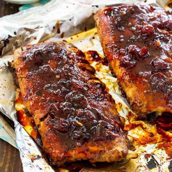 Ribs covered with glaze on a baking sheet.