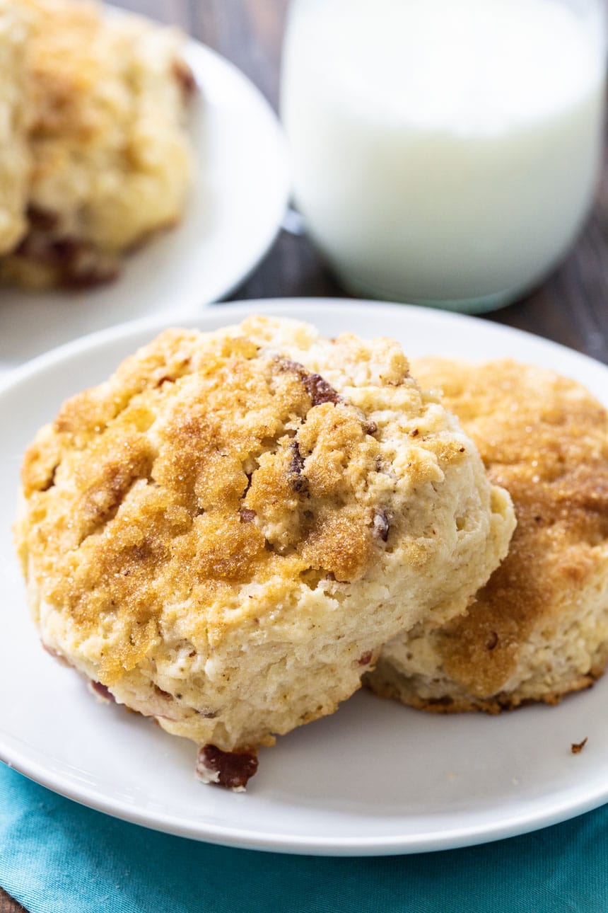 Brown Sugar Bacon Biscuits on a plate with buttermilk in background