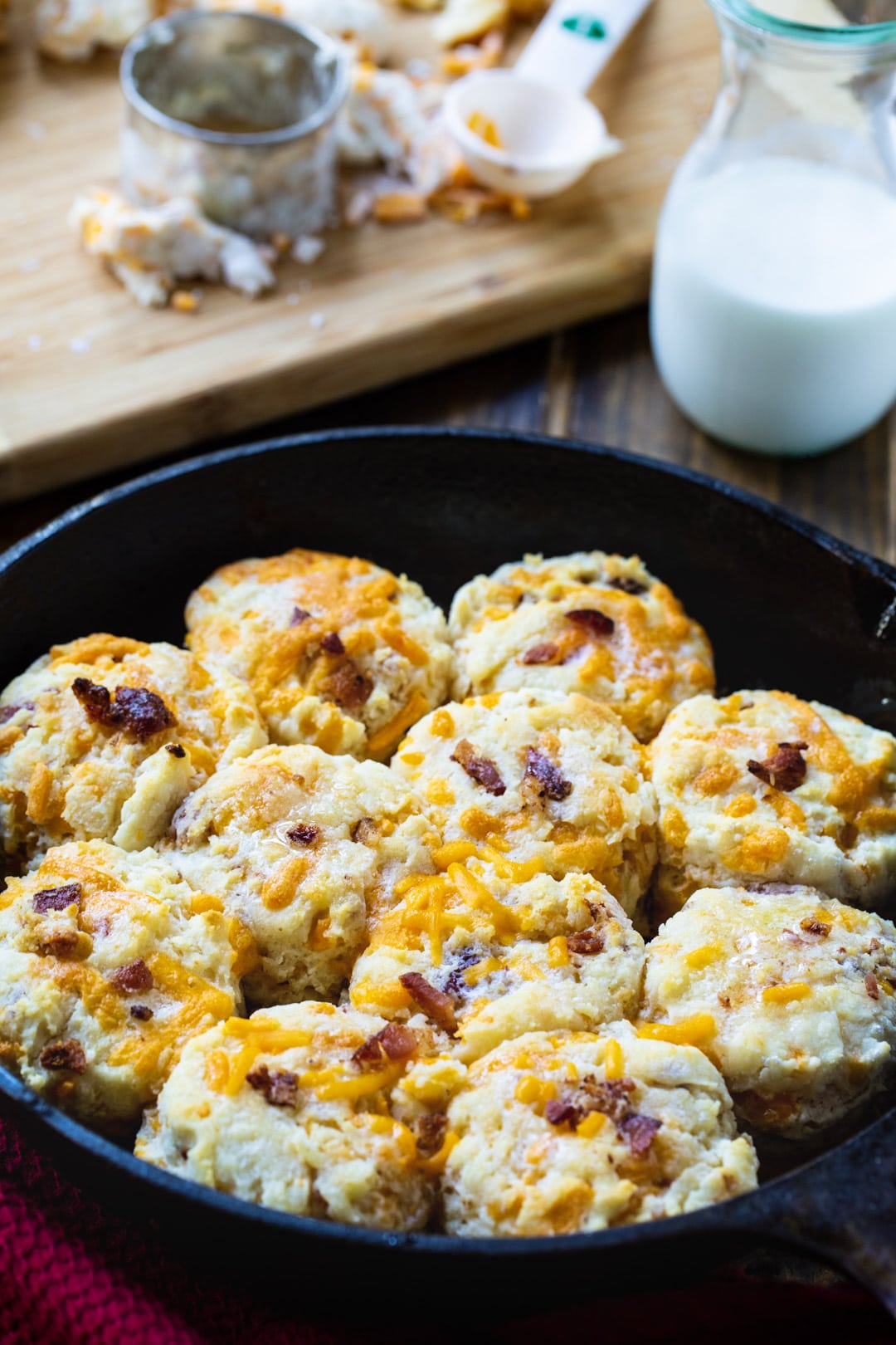 Bacon Cheddar Biscuits in a cast iron pan.