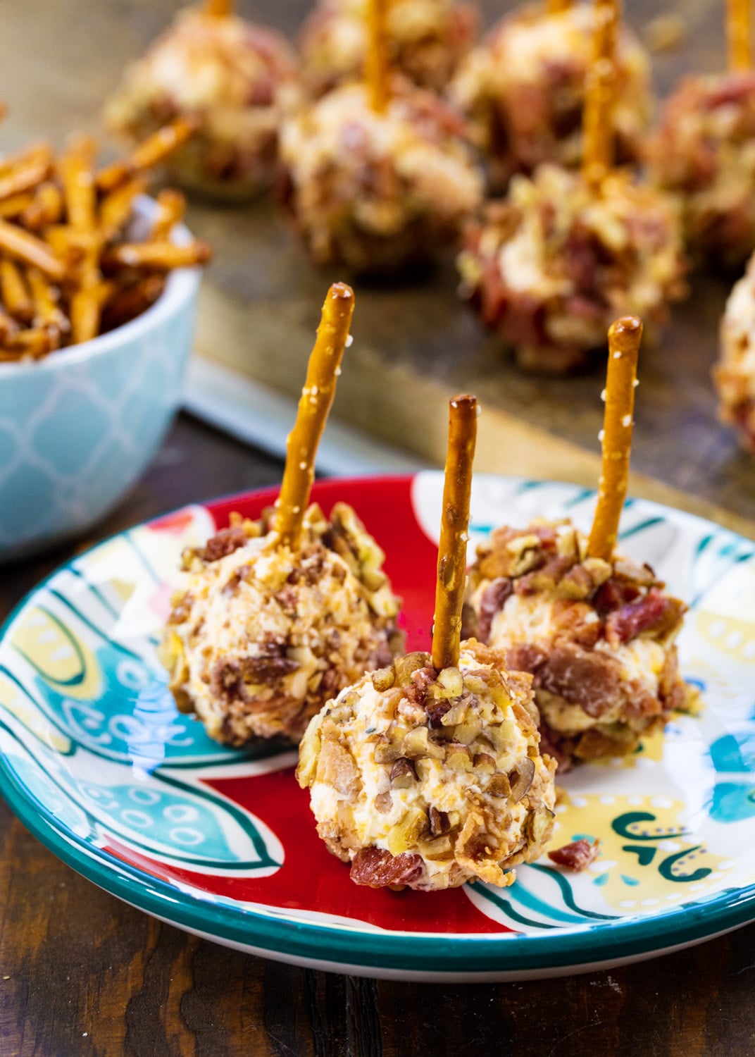 Three Bacon Cheese Ball Bites on a blue and red plate.