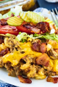 Bacon Cheeseburger Casserole with shredded lettuce and tomato on a plate.