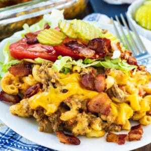 Bacon Cheeseburger Casserole with shredded lettuce and tomato on a plate.