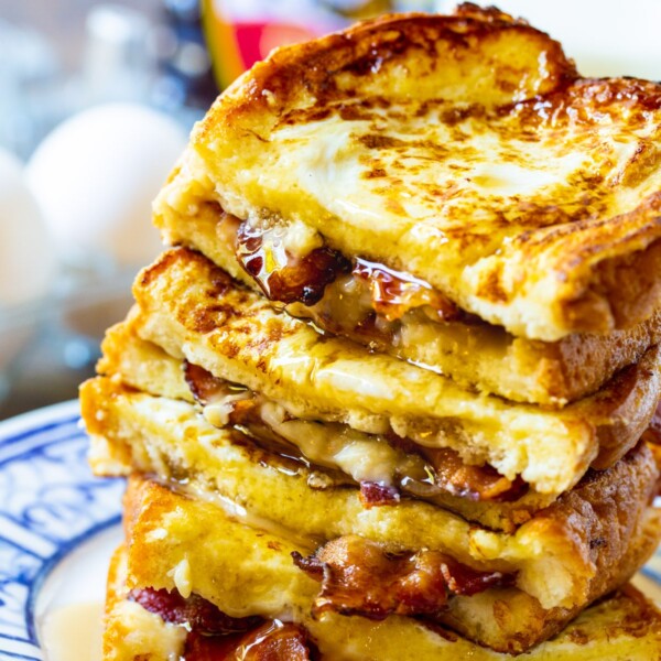 Bacon Stuffed French Toast stacked on a plate.