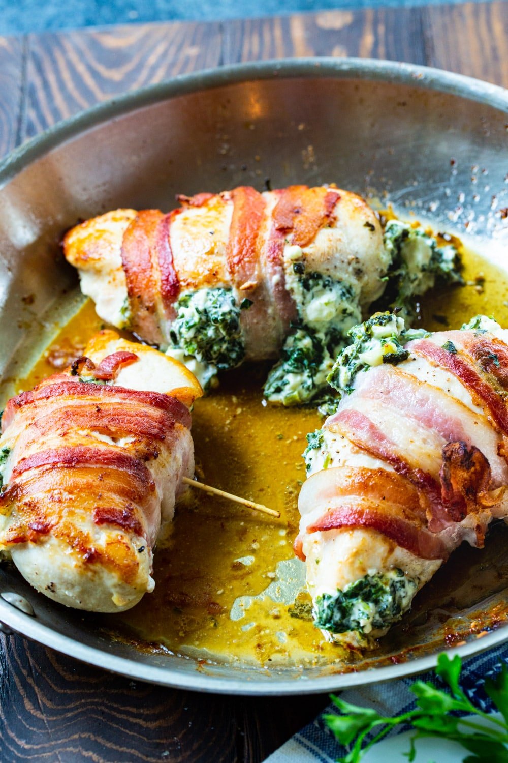 Stuffed Chicken Breasts in a skillet after being cooked.