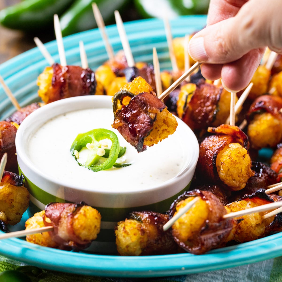 Jalapeno Bacon Tater Tot getting dipped in ranch dressing.