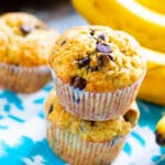 Two Banana Chocolate Chip MUffins stacked on top of each other.