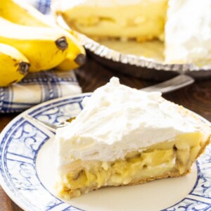 Slice of Banana Cream Pie on a blue and white plate