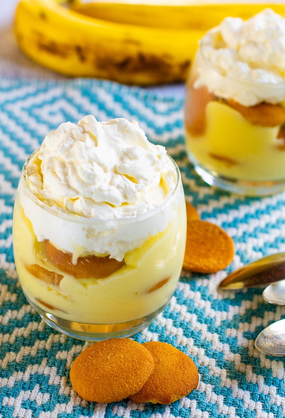Banana Pudding in 2 glasses with vanilla wafers around the glasses.