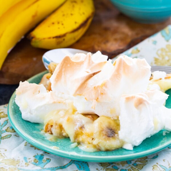 Serving of Banana Pudding with Meringue on a small green plate.