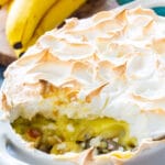 Banana Pudding with Meringue in baking dish with a serving scooped out.