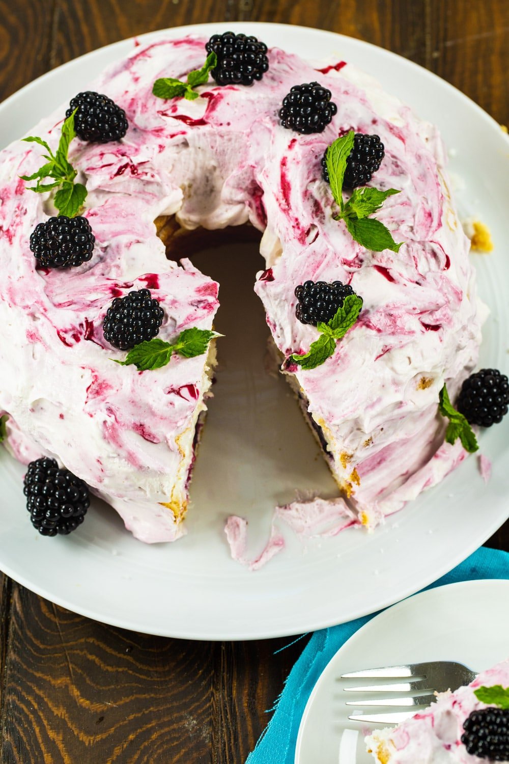 Angel Food Cake with blackberries with a slice cut out.
