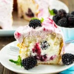 Slice of Blackberries and Cream Angel Food Cake on a plate.