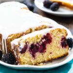 Buttermilk Loaf Cake with Blackberries on a white serving platter.