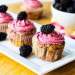 Cupcakes with Blackberries on a rectangular serving platter.