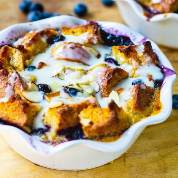 Blueberry White Chocolate Bread Pudding in a white ramekin.