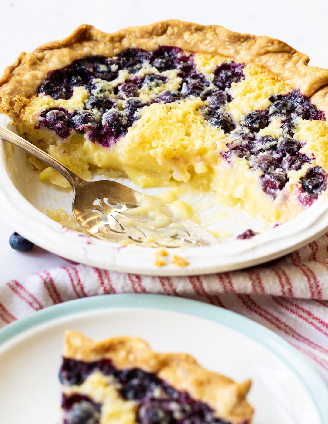 Blueberry Buttermilk Pie with several slices cut away.