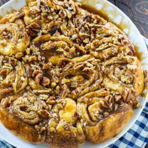 Cinnamon Rolls with Bourbon and Pecans on a white serving plate