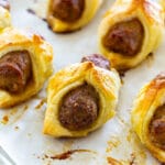 Breakfast Pigs in a Blanket on parchment paper.