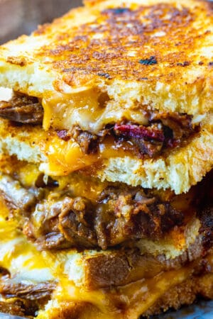 Brisket Grilled Cheese halves stacked on top od each other.
