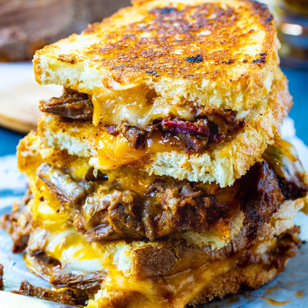 Brisket Grilled Cheese halves stacked on top od each other.