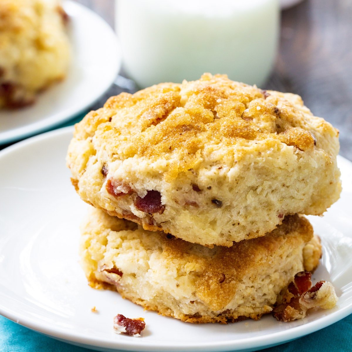Two Brown Sugar and Bacon Biscuits on a plate.