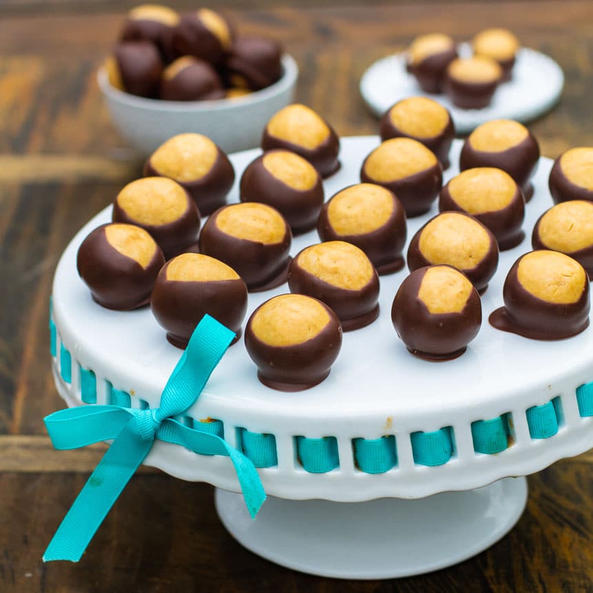 Buckeye Balls on a white cake stand.