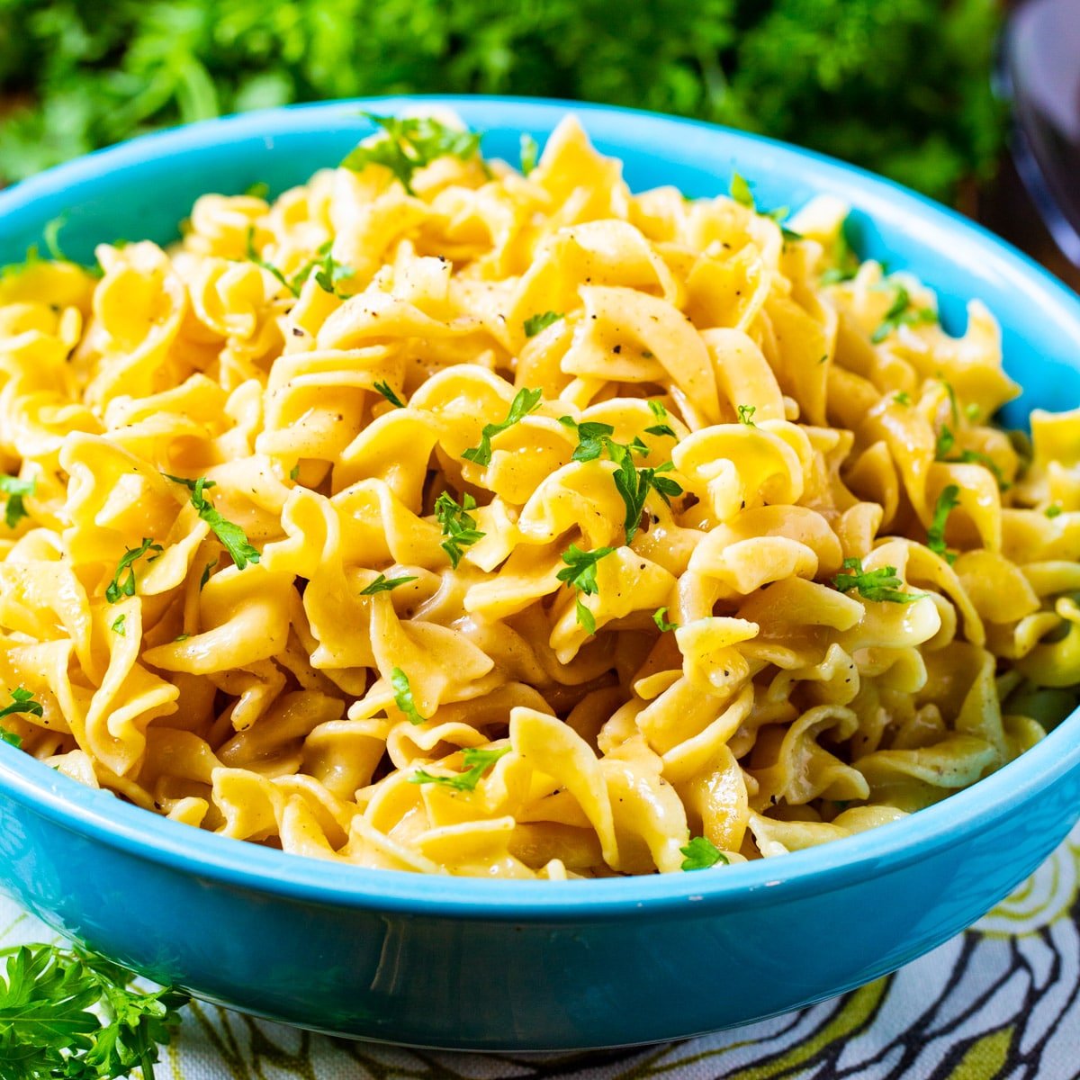 Buttered Noodles in a blue bowl.