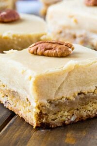 Butterscotch Blondies cut into squares with whole pecans on top.