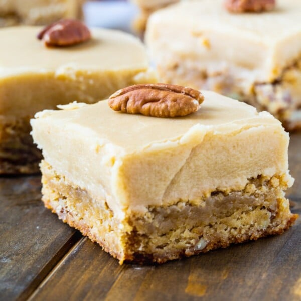 Butterscotch Blondies cut into squares with whole pecans on top.