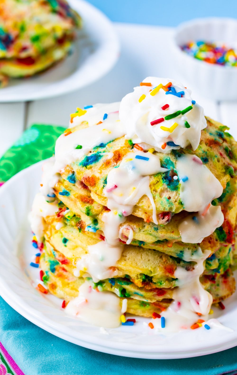 Stack of pancakes with glaze on a plate.