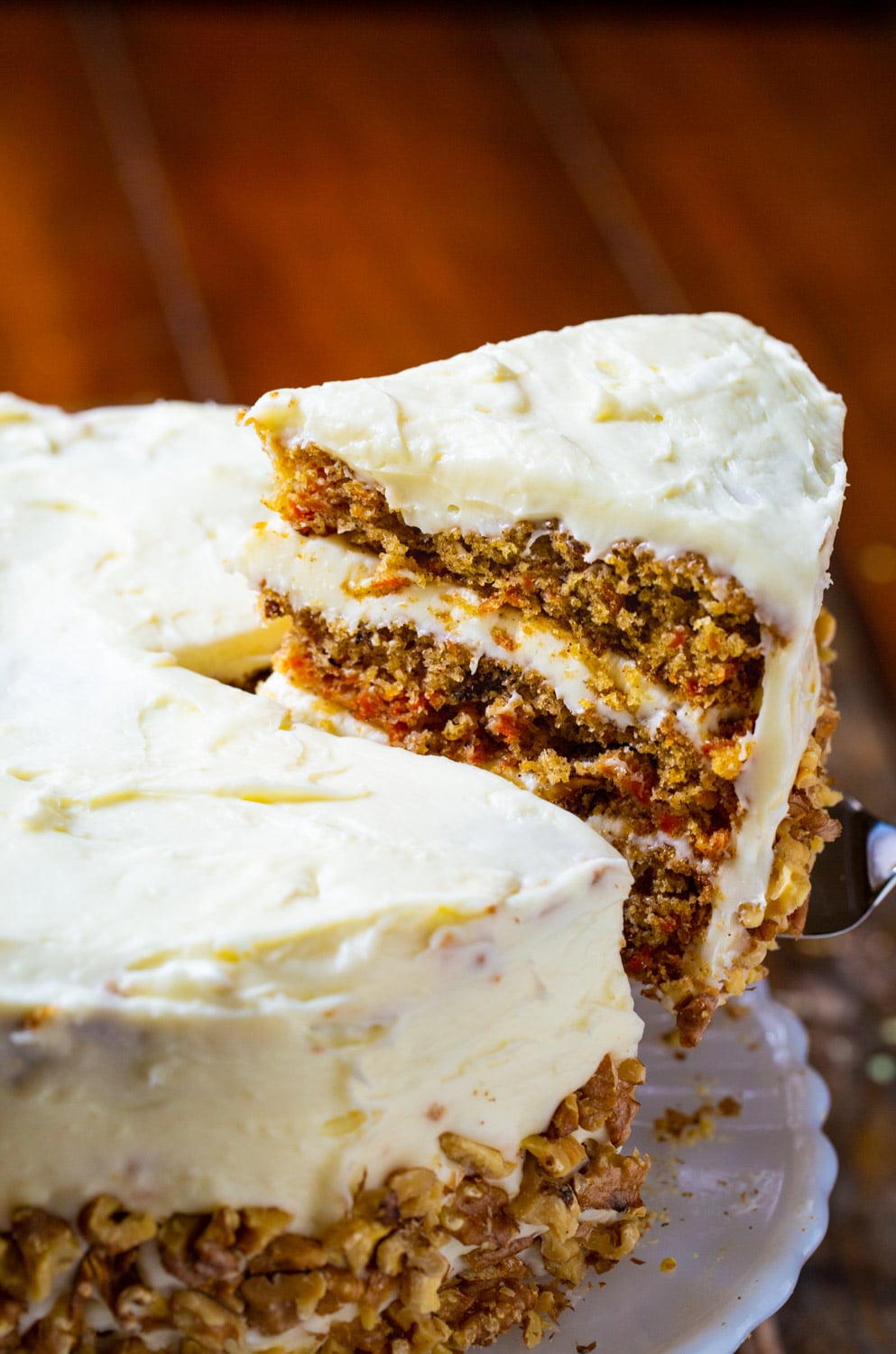 Slice of Carrot Cake being removed from rest of cake.