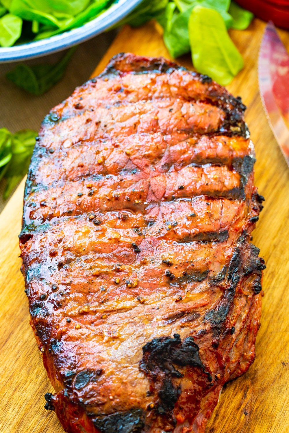 Grilled London Broil on a cutting board.