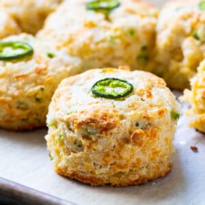 Jalapeno Cheddar Biscuits on parchment paper.