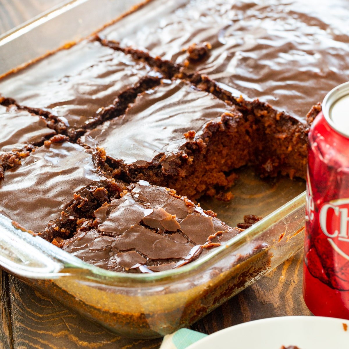 Cheerwine Chocolate Cake cut into squares in a baking dish.