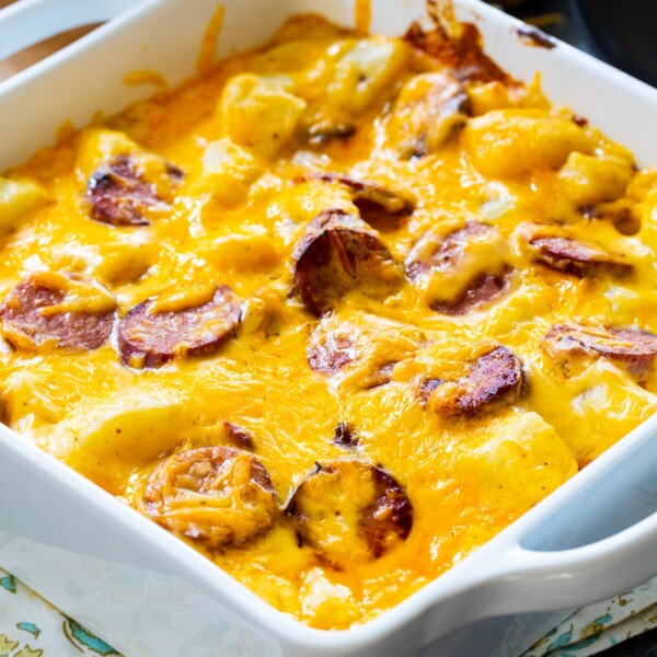 Cheesy Potatoes with Smoked Sausage in square baking dish.