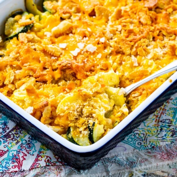 Spoon scooping Cheesy Squash, Zucchini, and Corn Casserole.