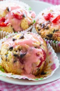 Three Cherry Chocolate Chip Muffins on a plate.