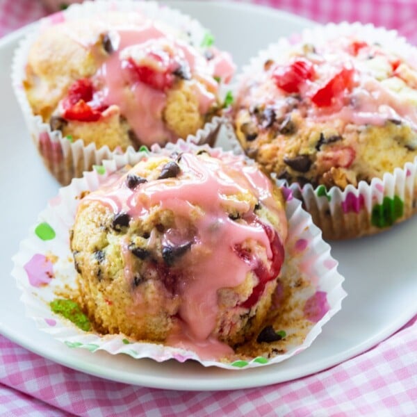 Three Cherry Chocolate Chip Muffins on a plate.