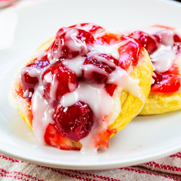 Two Cherry Danishes on a plate.