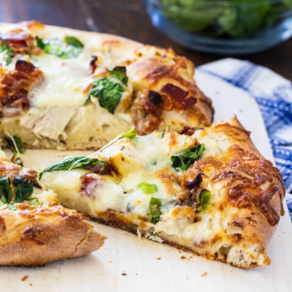 Chicken Alfredo Pizza with slice cut.