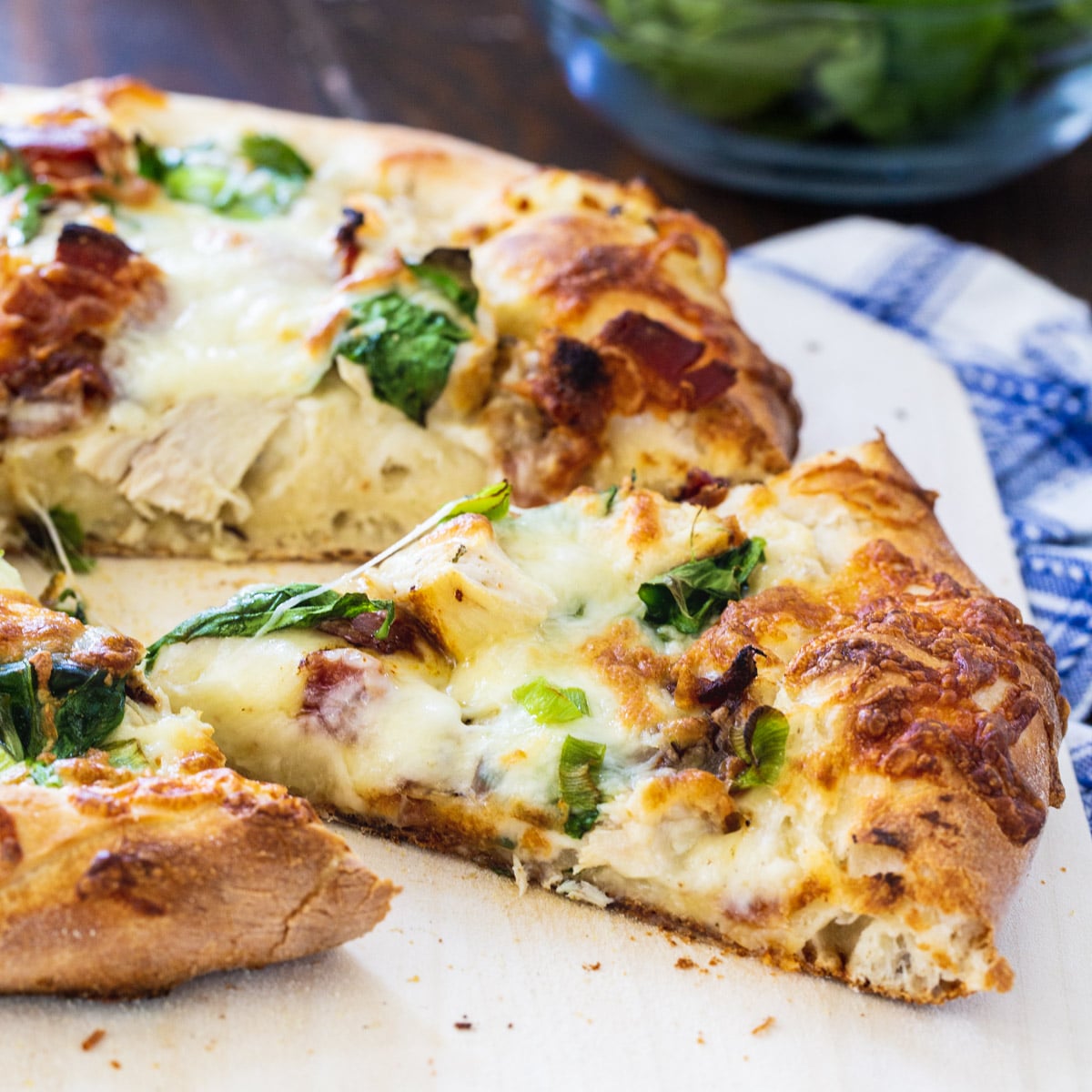 Chicken Alfredo Pizza with slice cut.