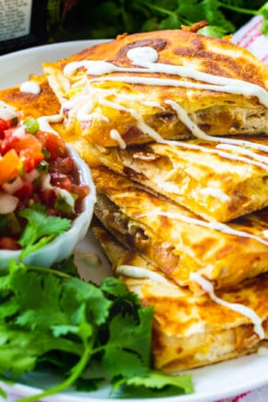 Chicken, Bacon and Ranch Quesadillas cut into triangles and stacked.